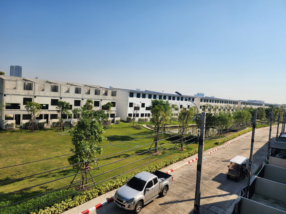 For SaleTownhomeBangna, Bearing, Lasalle : Townhome, 3 floors, 2 parking spaces, 3 bedrooms, 4 bathrooms, view in front of a large garden.